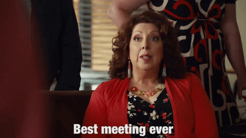 A woman at a conference table saying "Best meeting ever"
